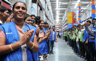 Employees celebrate the opening of a Best Price Modern store